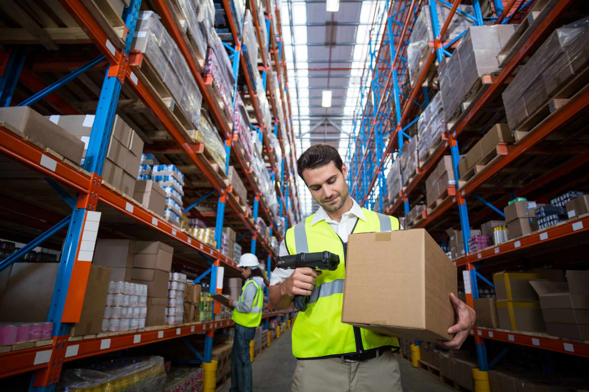 Worker scanning a box in warehouse