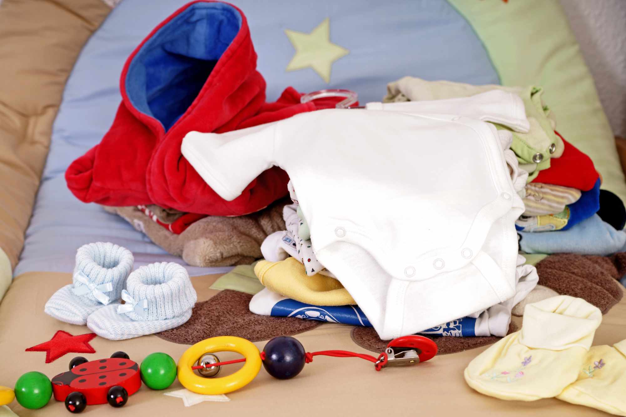baby clothes and toys on the ground