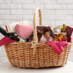 gift basket in a wicker basket white a white brick wall in the background