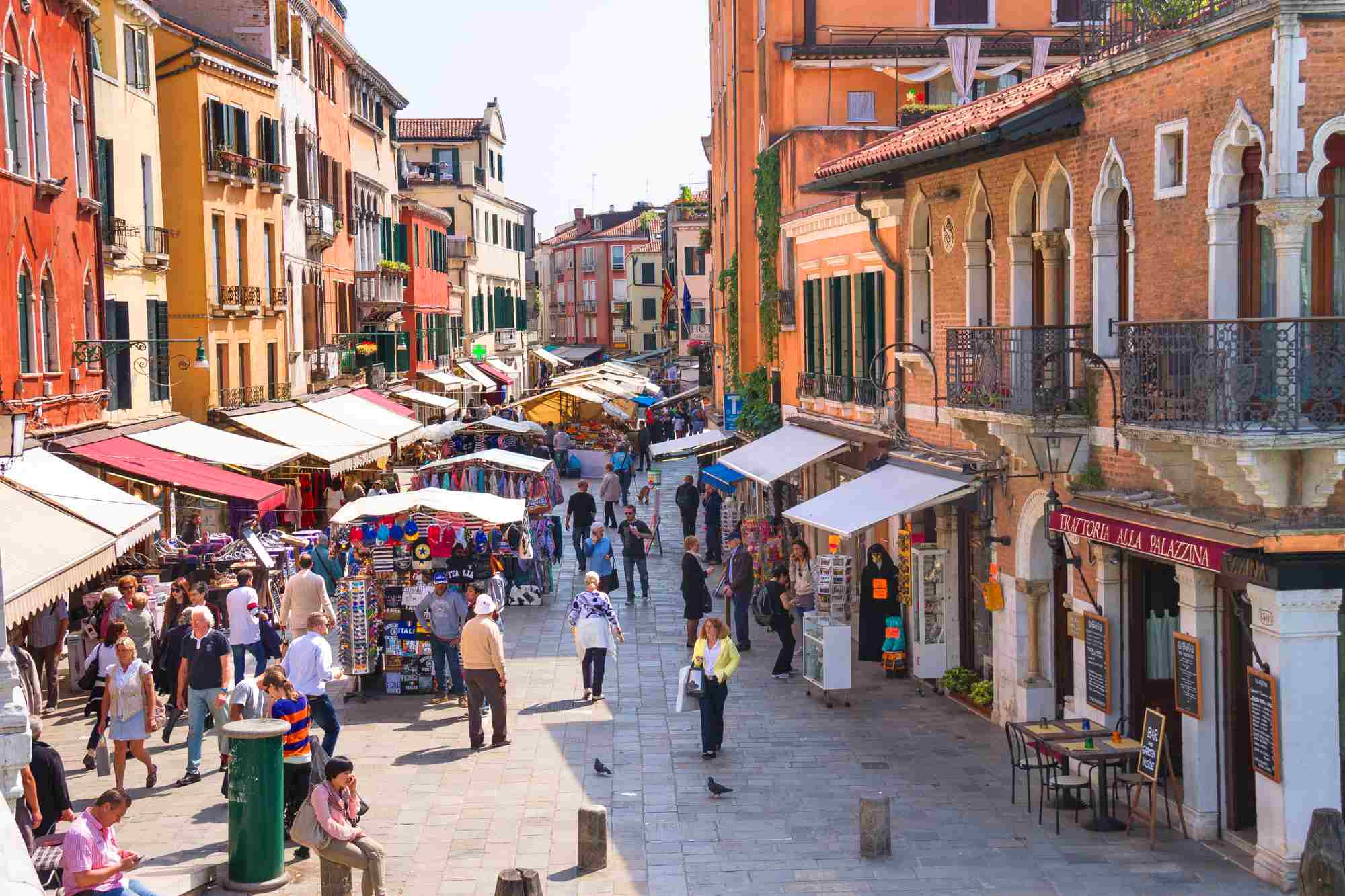 street in Venice, Italy with a lot of shops and a market