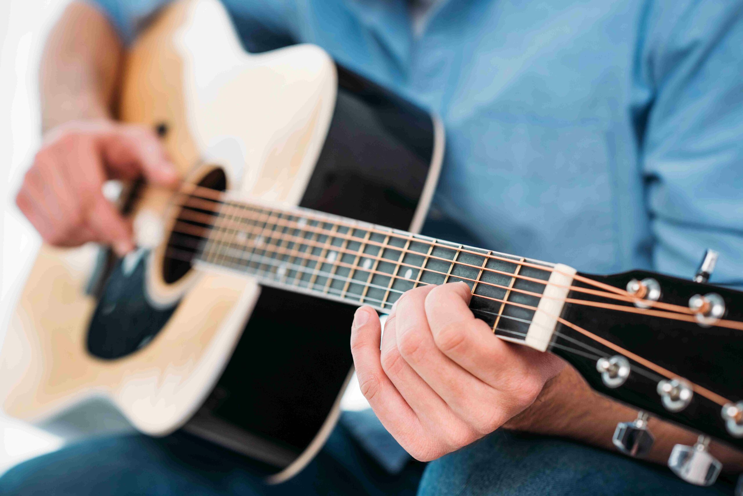 person playing an acoustic guitar