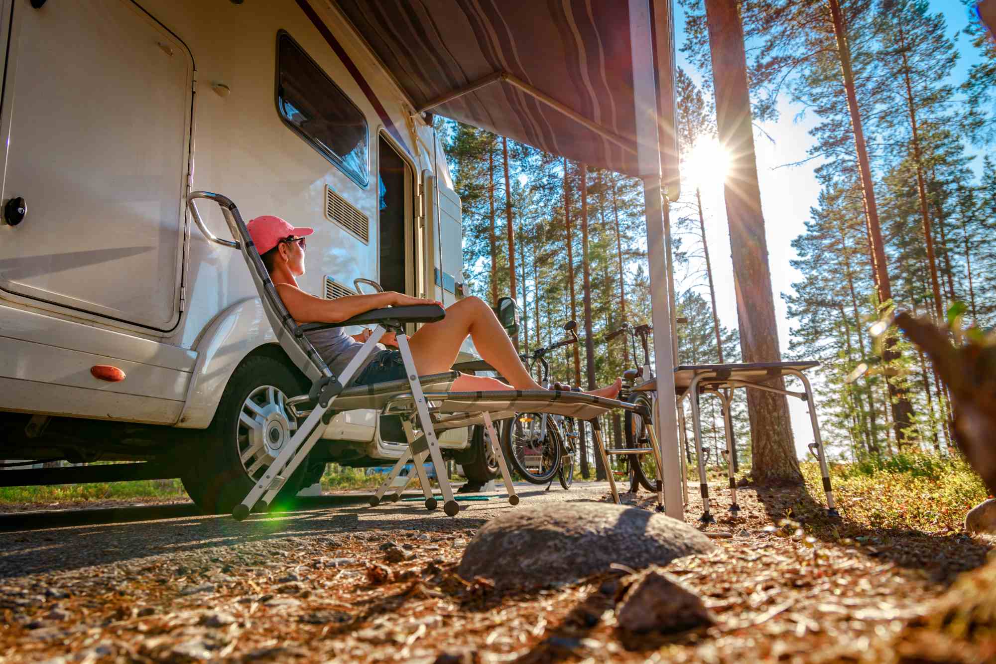 Relaxing with a dog by a camper on a campground