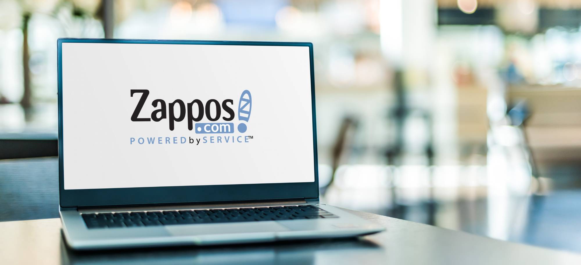 Zappos website open on a laptop with the background behind the laptop blurred